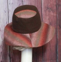 Wide Brim Sun Hat -Brown Wool with burgundy contrast print Inside black cotton band, the hat has a 2 section crown 3 1/2 " in length and a one piece 4" brim, and is lined in a cotton blend print. This hat is one size fits all and will fit 21" - 23" head size. Fitted Brown Brimmed Top Hat, Brown Sun Hat With Short Brim, One Size, Retro Brown Wide Brim Fedora, Adjustable Brown Sun Hat With Short Brim, Adjustable Brown Top Hat With Curved Brim, Brown Bucket Hat For Fall, Brown Wide Brim Fitted Hat, Retro Brown Hat With Curved Brim, Brimmed Brown Hats, One Size