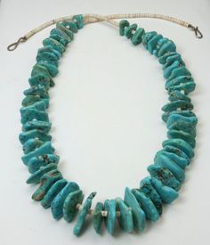 Vintage Santo Domingo Turquoise Pawn Nugget and Heishi Bead Necklace-Beautiful blue graduated nugget turquoise pawn stones!-Turquoise is an amazing sky blue and matched extremely well in a graduating size-Two white heishi beads between each piece of turquoise and about 3.8" of the same beads at the top of each strand-Nuggets range in size from 13mm x 11mm to the largest at 26mm x 17mm. Thickness measures about 3mm - 6mm-Beads are strung on a natural strong string which appears to be coated-Hook/ Artisan Turquoise Necklace With Large Beads, Traditional Turquoise Single Strand Jewelry, Unique Blue Single Strand Turquoise Necklace, Traditional Turquoise Single Strand Beaded Necklace, Unique Blue Turquoise Single Strand Necklace, Traditional Turquoise Single Strand Beaded Necklaces, Traditional Blue Turquoise Single Strand Necklace, Handmade Turquoise Agate Beaded Necklaces, Artisan Single Strand Turquoise Beads