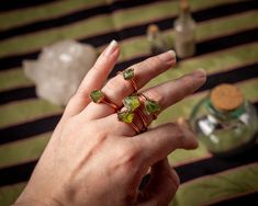 These rings feature raw Green Peridot set in pure textured copper.  Each one is unique. Size: Select below.  Custom sizes can be made upon request. These rings are not adjustable.  All pieces have been sealed against discoloration. All jewelry is one-of-a-kind and handmade by me for Bast & Baetyl Alchemy. Green Copper Rings As Gifts, Unique Green Copper Rings, Unique Green Copper Ring, Electroformed Metal Rings For Gift, Bohemian Green Electroformed Jewelry, Rustic Bronze Electroformed Jewelry, Electroformed Ring, Electroformed Leaf-shaped Copper Jewelry, Alchemy