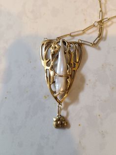 Hello! For sale is an unmarked, pure 14k floral theme and baroque pearl pendant necklace found at an estate sale. It has a Paperclip 14k chain attached, and while neither is marked 14k, acid and electronic testing confirms it is (and is not just plated or filled) Which is an interesting prospect - jewelry was required to be stamped with purity in the u.s. in early 20th century if it were being sold as that purity. I'm guessing this isn't THAT (1903) old, as it's in almost perfect condition, asid Antique Pearl Pendant Necklace For Formal Occasions, Antique White Gold Necklace With Pearl Pendant, Formal Art Nouveau Necklace, Formal Pearl Charm Brass Jewelry, Antique Formal Jewelry With Flower Pendant, Elegant Brass Jewelry With Flower Pendant, Elegant Baroque Jewelry With 17 Jewels, Antique Flower Pendant Jewelry For Formal Occasions, Ornate Yellow Gold Pearl Drop Jewelry