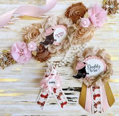 three baby girl hair clips with pink and brown flowers on them, one is for daddy to be