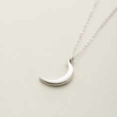 The necklace with the image of a delicate new moon is You can wear it simply and without hesitation.  The moon motif of thes necklace is somewhat mysterious and gentle. Matching earrings are also available. Anyway, I recommend this jewelry as a cute and versatile bracelet! "Sterling Silver" Sterling silver(sv925)  Made in Japan.  Care Guide To make your delicate jewelry last for a long time, please follow these guidelines: Avoid putting on or taking off clothes while wearing jewelry, as it can c Dainty Silver Moon Shaped Jewelry, Silver Crescent Sterling Silver Charm Necklace, Elegant Silver Charm Necklace With Moon Charm, Sterling Silver Moon Phase Charm Necklaces, Sterling Silver Moon Clavicle Chain, Sterling Silver Moon Clavicle Chain Jewelry, Elegant Sterling Silver Crescent Charm Necklace, Elegant Everyday Crescent Charm Necklace, Sterling Silver Moon Charm Pendant Necklace