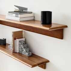 two shelves with books and other items on them