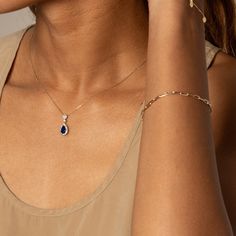 Make a statement with a teardrop-shaped sapphire pendant surrounded by a white sapphire halo. Crafted from solid 10k gold and 925 sterling silver in a two-tone style, it features a lab-created blue sapphire of 1.28 ct and a lab-created white sapphire halo of 0.38 ct.Pendant only, chain sold separately Blue Teardrop Pendant Jewelry With Diamond Accents, Blue Teardrop Pendant With Diamond Accents, Blue Teardrop Jewelry With Diamond Accents, Blue Teardrop-shaped Jewelry With Diamond Accents, Fine Jewelry Sapphire Teardrop Pendant, Sapphire Teardrop Pendant Fine Jewelry, Teardrop Sapphire Jewelry With Diamond Cut, White Gold Sapphire Teardrop Pendant Jewelry, Sapphire Teardrop Pendant Jewelry