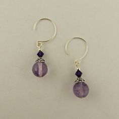 I created these earrings using Sterling silver hoops 8mm Round Faceted Genuine Amethyst 4mm Bicone Purple Velvet Amethyst  2mm round Sterling silver beads Sterling silver bead caps Check my other listings for more handcrafted jewelry as well as beads, charms and findings to create your own jewelry Insured USPS shipping in a padded envelope with a tracking number Bicone Bead Earrings, Nickel-free Sterling Silver Round Bead Jewelry, Nickel-free Sterling Silver Jewelry With Round Beads, Sterling Silver Faceted Beads Earrings For Gift, Faceted Czech Glass Round Beads Jewelry, Birthstone Round Beads For Jewelry Making, Adjustable Purple Round Hoop Earrings, Adjustable Purple Hoop Earrings, Sterling Silver Earrings With Faceted Beads For Gifts