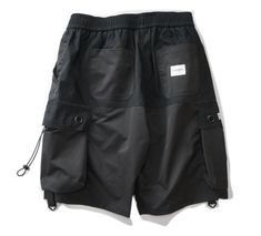 Stay agile in the city with our lightweight men's cotton shorts. Unveiling our latest addition to the urban wardrobe - our utility jogger shorts for men, the definitive staple for every trend-forward city-dweller. Crafted to be lightweight and comfortable, these urban shorts are, in essence, your summer armor. They come equipped with two black straps and drawstrings on each cargo pocket, lending an enhanced tactical vibe to your appearance. This feature adds an extra layer of sophistication and Urban Style Summer Shorts, Urban Knee-length Summer Shorts, Black Cargo Style Shorts For Outdoor Activities, Black Cotton Cargo Shorts For Outdoor Activities, Cotton Cargo Style Techwear Shorts, Techwear Cotton Cargo Shorts, Black Techwear Shorts With Cargo Style, Cotton Techwear Shorts With Side Pockets, Relaxed Fit Streetwear Athletic Knee-length Shorts