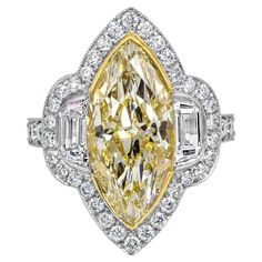 An elegant engagement ring, showcasing a vibrant 5.43 carats marquise cut diamond certified by GIA as Fancy Yellow color and VVS1 clarity, set on 18K yellow gold. Flanked by half moon diamonds weighing 0.79 carat total, set in an intricately designed platinum setting. Accented with a halo of round brilliant cut diamonds that continue on to the shank in a half-eternity design. Accent diamonds weigh 1.01 carats total. Size 6 US, resizable upon request. Roman Malakov is a custom house, specializing Three Stone Engagement Rings Halo, Big Diamond Engagement Rings, Antique Style Engagement Rings, Contemporary Engagement Rings, Elegant Engagement Rings, Diamond Halo Engagement Ring, Modern Engagement Rings, Engagement Ring Diamond Cut, Emerald Engagement Ring Cut