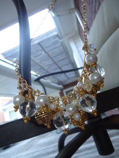 This Cluster Necklace created by Jewelry By Luet and Co is made of white glass pearls, clear glass and acrylic beads, gold plated:  chain, beads and findings.  This necklace measures 22 1/4 inches in length.View more chain necklaces:  http://www.etsy.com/shop/cdjali?section_id=10221957[N-1] Gold Jewelry With Pearl Charm And Crystal, Wedding Gold Pearl Necklace With Dangling Beads, Gold Pearl Necklace With Dangling Beads For Wedding, Gold Beaded Chain Bridal Necklace For Party, Gold Pearl Jewelry With Dangling Beads, Gold Pearl Necklaces With Dangling Beads, Gold Bridal Necklace With Beaded Chain For Party, Gold Pearl Bridal Necklace In Costume Style, Gold Bridal Necklace With Dangling Beads For Wedding