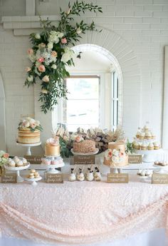 a table topped with lots of cakes and cupcakes