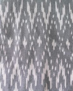 an upholstered fabric with white and grey designs