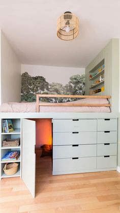 there is a loft bed in the middle of this room with built - in desks