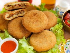 some fried food is on a plate with sauces and condiments next to it