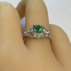 This is part of Chairish’s Fine Jewelry assortment.  Introducing the Emerald Diamond 0.90 Carat Platinum Filigree Milgrain Trim Engagement Ring, finger size 6.5 – a timeless symbol of your love and commitment. This exquisite piece combines classic elegance with intricate details, making it the perfect choice for your special moment. 1. Stunning Round Emerald, weighing 0.60 Carat and Diamonds weighing 0.30 Carat: At the heart of this engagement ring lies a breathtaking round emerald and diamonds. Luxury Solitaire Emerald Ring For Formal Occasions, Timeless Green Diamond Promise Ring, Art Deco Green Ring, Gia Certified, Art Deco Green Ring Gia Certified, Timeless Green Baguette Cut Ring, Classic Emerald Diamond Promise Ring, Classic Emerald Ring For Promise, Classic Brilliant Cut May Birthstone Ring, Green Diamond Platinum Ring Fine Jewelry