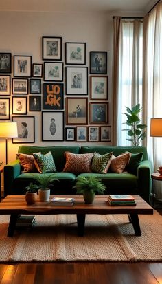 a living room with green couches and pictures on the wall above them, along with a coffee table