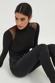 Break the mold with Maria, our turtleneck with a twist. Fashioned from a high-stretch, silky soft combination of sustainable European jersey and European mesh, she features unique symmetrical mesh panels that reveal the perfect amount of shoulder. Maria can be effortlessly dressed up or down—your choice! [SPLIT] Sam, in black, is 5'8" (173 cm) tall, wearing size XS. Steph, in off white, is 5'11" (180 cm) tall, wearing size XS. Total length approximately 28" (70 cm). Sustainable European Jersey ( Elegant High Neck Mesh Top For Layering, Chic Fitted High Neck Mesh Top, Elegant Stretch Mesh Top, Elegant High Neck Stretch Mesh Top, Black Turtleneck Mesh Top For Night Out, Chic High Neck Mesh Top With Sheer Sleeves, Black Turtleneck Mesh Top With Sheer Sleeves, High Neck Mesh Top With Sheer Sleeves For Layering, Sheer Sleeve High Neck Mesh Top For Layering