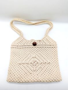 This vintage macrame purse is a beautiful addition to any boho hippie collection. Handmade in the People's Republic of China, this original piece features intricate ivory cotton macrame detailing. The purse is perfect for carrying everyday essentials and adds a touch of unique and versatile style to any outfit. Measures approx 10" wide and 8.5" tall Vintage used condition. Natural Crochet Bag For Festival, Natural Crochet Festival Bag, Vintage Natural Crochet Bag, Vintage Woven Crochet Bag In Natural Color, Handmade Bohemian Shoulder Bag With Adjustable Strap, Beige Rectangular Crochet Bag For Festival, Bohemian Fair Trade Crochet Bag For Beach, Bohemian Handmade Adjustable Shoulder Bag, Rectangular Beige Crochet Bag For Festivals