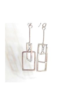 "These geometric  rectangular earrings are interconnected perpendicularly to one another, and look great from every angle!  Handcrafted from sterling silver and measure approximately 2\" in length. Made to order can be customized! With sterling silver ear hook. ~ All jewelry is boxed and ready for gift giving. DETAILS: ~ Components are sterling silver  ~ Earrings measure approximately 2\" in length  ~ Ships at no extra charge. ~ Gift wrapping option available at checkout. Include a special message in the card. ~ Handmade in Austin, Texas ❤️YOU MAY ALSO LIKE THESE ITEMS❤️ https://www.etsy.com/listing/55801648/square-dangle-earrings?ga_search_query=rectangle&ref=shop_items_search_4&frs=1 https://www.etsy.com/listing/270702625/silver-sliver-over-darkened-copper?ga_search_query=rectangle&ref=s Minimalist Silver Rectangular Earrings, Modern Silver Earrings With Rectangular Pendant, Modern Silver Rectangular Pendant Earrings, Modern Silver Rectangular Earrings, Modern Handmade Oblong Earrings, Modern Oblong Sterling Silver Earrings, Modern Sterling Silver Oblong Earrings, Everyday Modern Rectangular Linear Earrings, Modern Square Nickel-free Earrings