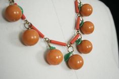 "vintage bakelite necklace luxurious statement piece celluloid chain w. dangling charms luminous orange bakelite all original - w. hook clasp closure spectacular piece - highly collectible circa 1940's condition: very good + minimal wear doesn't distract from overall impact measures: necklace length: approx. 20\" long ( measured flat & open ) feel free to ask any questions - happy to help item is vintage & in used condition layaway is available ! message for more details" Handmade Retro Bakelite Jewelry, Vintage Handmade Orange Necklace, Golden Fruit, Bakelite Necklace, Oddly Specific, Bakelite Jewelry, Necklace Orange, Lucite Jewelry, Machine Age