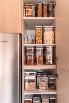 an organized pantry with lots of food and containers