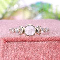 a close up view of a ring on a pink blanket