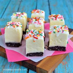 several pieces of cake sitting on top of a pink paper towel with sprinkles