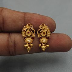 Beautiful yellow gold earrings Gold Purity- 22k yellow Gold Length -2.3 cm Width - 1.1 cm Weight - 3.37 grams approx The earrings comes with normal push/backs. If you want real gold push/back please let us know. Ornate Gold Dual-tone Earrings, Festive Dual-tone Earrings For Puja, Festive Earrings With Intricate Design For Puja, Gold Dual-tone Temple Jewelry Danglers, Gold Dual-tone Danglers, Yellow Gold Chandbali Earrings For Navratri, Dual-tone Temple Jewelry Earrings For Puja, Intricate Bridal Earrings For Diwali Puja, Dual-tone Earrings For Puja And Festivals