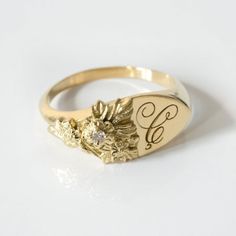 This vintage-inspired floral ring is a row of dainty flowers wrapped around your fingers. Handmade and polished, it is available in solid 8K and 14K gold. This item is engravable with text or monogram of your choice at no extra cost. The initals are engraved onto the ring and embedded in the 3D model for a flawless embossed finish. It is also possible to add a diamond or birthstone or diamond to this ring at an additional fee. Please inquire for details. A few notes about our gold:- Though we do Classic Round Birth Flower Jewelry, Anniversary Jewelry With Rose Cut Diamonds In Flower Shape, Flower Shaped Rose Cut Diamond Jewelry For Anniversary, Flower-shaped Rose Cut Diamond Jewelry For Anniversary, Heirloom Yellow Gold Jewelry With Birth Flower, Heirloom Yellow Gold Birth Flower Jewelry, Vintage Personalized Jewelry For Promise, Heirloom Birth Flower Jewelry, Elegant Gold Signet Ring With Birth Flower