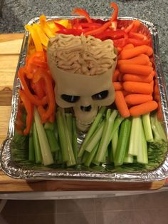 a tray filled with vegetables and a human head