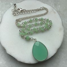 "A green natural stone Oval shaped pendant, in a Rhodium plated setting, suspended on a Rosary beading and silver plated chain, this necklace is great for day or evening wear. MATERIAL Silver Plated Chain - Nickle Free   Green rosary chain Green natural stone Pendant MEASUREMENTS Overall length incl chain extn 24\"/61cms Pendant length - 1.25\"/3cms PRESENTATION The Necklace will be attached to Giftcard, Giftwrapped in Tissue and tied with Ribbon, presented in a Organza Pouch - Perfect if you are sending direct as a Gift - I can also enclose a Message on your behalf, just message me the details. DELIVERY All Purchases are despatched 1st Class, Signed U.K Delivery - Tracked Worldwide with Royal Mail, to ensure a quick delivery. ESTIMATED DELIVERY TIMES U.K - 1 - 3 Days USA - CANADA - 5 - 10 Jade Pendant Necklaces For Crafting, Elegant Silver Jade Beaded Necklace, Green Jade Jewelry With Adjustable Chain, Green Teardrop Jewelry With Adjustable Chain, Green Drop Jewelry For Jewelry Making, Nickel-free Green Drop Jewelry, Green Nickel-free Drop Jewelry, Green Pendant Necklace With Beaded Chain, Green Beaded Chain Pendant Necklace