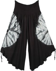 A cropped wide-leg pant. features smocked elastic waistband, 2 front tie pockets, and tie ruffle leg opening. A chic pair of wide-leg culotte pants in black with a white tie-dye that goes around the middle of the pants, back, and front. This style is totally fresh and you will be ahead of fashion. The front pockets come with a functional tie-up string that gives it a boho look. Similar functional tie-ups are attached at the bottom of these pants and can be pulled to make the leg opening higher.