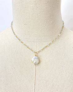 This elegant Baroque Pearl and Aquamarine Necklace is a luxurious statement piece featuring a large baroque pearl suspended on a chain of shimmering micro-faceted pale blue aquamarine gemstone beads, all handcrafted with beautiful gold fill. This coastal-inspired necklace is perfect for adding an elegant touch to any look, either solo or layered with other pieces. Necklace length: 16 inches plus 2 inch extender Materials: baroque pearl, aquamarine gemstone beads, gold filled clasp, wire and comp Baroque Pearl Pendant, Aquamarine Necklace, Aquamarine Beads, Inspired Necklace, Station Necklace, Childrens Jewelry, Aquamarine Gemstone, Gemstone Necklace Pendant, Aquamarine Blue