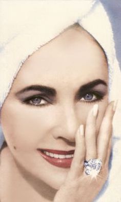 a woman with a towel on her head and a diamond ring on her left hand