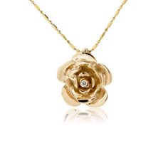 14K Gold .035ctw Diamond Rose Pendant Brilliant petals of 14K rose gold are accented with a single shimmering diamond which is prong set at the center of this golden rose. The timeless beauty of a rose is echoed in this rose and diamond pendant, designed and hand crafted by the amazing artists at Park City Jewelers. Your rose pendant will be created for you in your choice of 14K yellow gold, 14K white gold, or 14K rose gold. The chain is not included with this pendant. Chain is not included Prod Rose Pendant Gold, Gold Diamond Jewelry With Rose Design, Milestone Photos, Amazing Artists, Gold Apple, Gold Pendant Jewelry, Flower Style, Rose Pendant, Baby Milestone