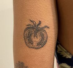 a close up of a person's arm with a tattoo on the side of her leg