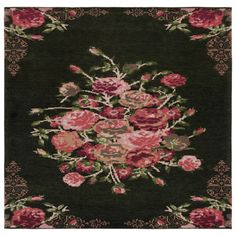 a black rug with pink flowers and green leaves on the bottom, in an ornate frame