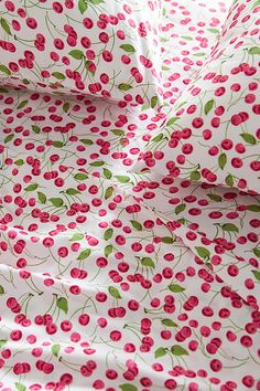 a white sheet with red cherries on it