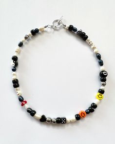 "Necklace beaded by me with luuvvvv <3 Will look very similar to photos. Has all different sizes of black and white freshwater pearls, that will vary due to natural variation. Circle toggle clasp closure, all necklace will have orange & yellow smiley face, red mushroom, 8ball, yin yang and dice.  Necklace in photos is 18\"." Trendy Black Beaded Necklaces With Round Beads, Trendy Black Beaded Necklace Gift, Black Bohemian Letter Beads, Bohemian Black Letter Beads, Black Necklaces With Round Letter Beads, Trendy Black Necklace With Colorful Beads, Casual Black Beaded Necklace With Colorful Beads, Black Beaded Necklace With Letter Beads, Black Beaded Necklace With Letter And Round Beads