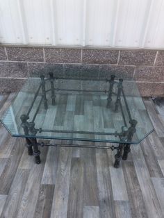 a glass table sitting on top of a wooden floor