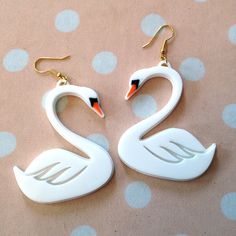 "Swans are the drag queens of the bird world, I think. Graceful, yes, But if you get in their way, they'll mess you up. I designed the pendants on my computer and laser cut them from acrylic. I used 1/8\" acrylic backed with 1/16\" acrylic for support. These earrings measure around 2.5\" long and 2\" wide. These hang from gold earring hooks. If you prefer wrap around hooks (that work for plugs) no problem- just drop me a line in the notes to seller section! Did you know that almost all of our la Acrylic Laser Cut Earrings, Swan Earrings, Homemade Signs, Weird Jewelry, Laser Cut Wood Crafts, Gold Hooks, Laser Cut Earrings, White Swan, Drag Queens