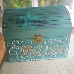 a wooden box with the word melina painted on it's front and side