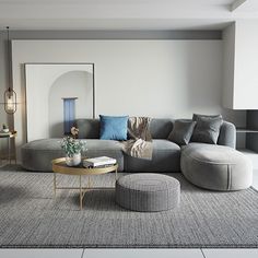 a living room filled with furniture and a large mirror on the wall above it's headboard