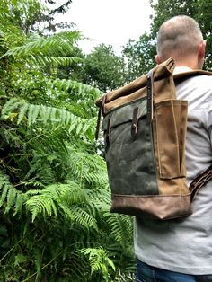 "Medium size backpack made from heavy weight waxed canvas in the color spice with an outside pocket made in waxed canvas color olive green. I made it into an everyday backpack/rucksack, with waxed canvas padded straps. Roll to close top, and outside pocket with protective flap. The bottom is made in oiled leather in the color brown. This backpack as a bottle pocket on one side The bag closes with roll to close system and snaps with a vegetable tanned leather strap. This medium size pack is fully Khaki Waxed Canvas Backpack For Outdoor, Khaki Waxed Canvas Backpack, Khaki Waxed Canvas Standard Backpack, Waxed Canvas Leather Backpack, Hipster Backpack, Waxed Canvas Backpack, Commuter Backpack, Everyday Backpack, Roll Top