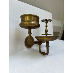 two brass candlesticks sitting next to each other