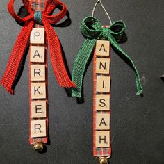 two wooden scrabbles tied to each other with bows and letters on them