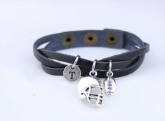 two leather bracelets with football charms on them