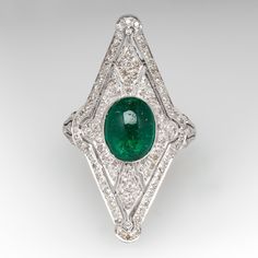 This exquisite ring features a pierced design, centered with an oval, emerald cabochon, weighing 1.75 carats, in a full bezel setting, accented with milgrain details. The top of the ring is accented with one hundred six (106) bead set, round single cut diamonds. The ring measures 31.9mm at the top, rises 8.0mm above the finger, tapering to 1.5mm wide and 0.8mm thick at the base of the shank. This ring is currently a size 5.75. The emerald has surface reaching natural inclusions. Fine Jewelry Emerald Oval Cabochon Ring, Fine Jewelry Emerald Ring With Oval Cabochon, Luxury Oval Emerald Birthstone Ring, Luxury Emerald Ring With Oval Cabochon, Elegant Emerald Ring With Cabochon Cut, Elegant Cabochon Emerald Ring, Elegant Emerald Cabochon Ring, Classic Diamond Ring With Cabochon Cut, Classic Diamond Cabochon Ring