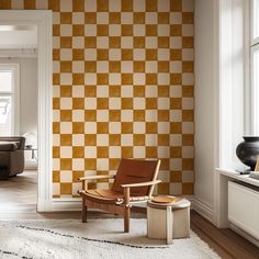 a chair and ottoman in front of a checkerboard wallpapered living room