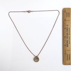 "A unique necklace that I made with an original Fort Wayne Transit token (this token was first used in 1950). I polished the token to bring out the writing and color (solid bronze). The first two photos show both sides of the coin (same design on both sides). 5/8\" in diameter. The chain is an antiqued bronze/copper tone chain with nice lobster claw clasp (you can choose 18\" or 20\" length). It will come in a new gift box and this will be the exact token you receive. If you need more than one, Vintage Hand Forged Gold Necklace, Vintage Gold Hand Forged Necklace, Vintage Gold Hand Forged Necklaces, Nickel-free Brass Necklace In Brown, Vintage Adjustable Necklaces For Everyday Use, Bronze Round Pendant Necklace With Antique Finish, Bronze Antique Finish Round Pendant Necklace, Vintage Everyday Necklace, Vintage Brass Charm Necklace