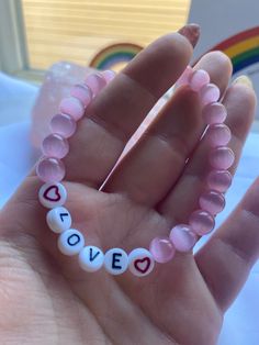 Stretch bracelet with glass & plastic beads. Adjustable Pink Heart Bracelet With Letter Beads, Affirmation Beaded Bracelets, Cute Heart-shaped Bracelets With Letter Beads, Playful Pink Letter Beads Charm Bracelet, Pink Heart-shaped Name Bracelet With Letter Beads, Isabel Larosa, Word Bracelets, Love Affirmation, Affirmation Bracelets