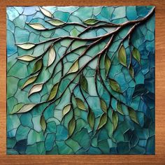 a piece of art that is made out of stained glass and has leaves on it